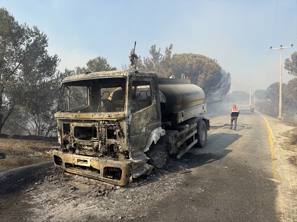 Balıkesir'in Gömeç ilçesinde başlayıp Ayvalık'a sıçrayan orman yangınında alevlerin arasında kalan İzmir Büyükşehir Belediyesine ait bir su tankeri yandı. / Foto: AA
